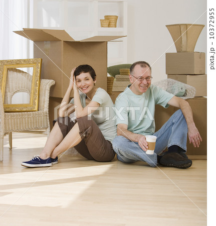 Couple on floor next to moving boxes 10372955