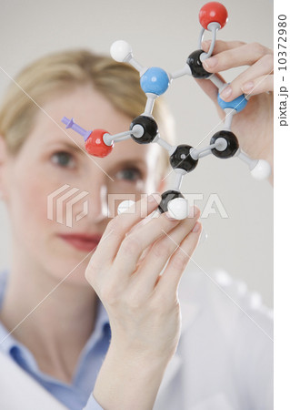 Female scientist looking at molecule model Female scientist looking at molecule model 10372980