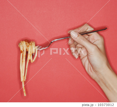 Woman holding forkful of pasta 10373012