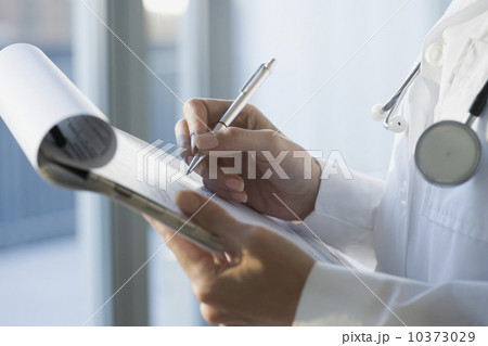 Close up of doctor writing on medical chart 10373029