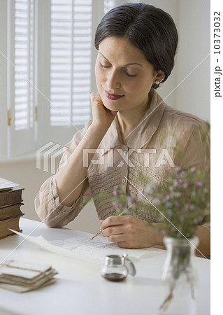 Woman in vintage clothing writing letter 10373032