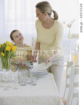 Mother and daughter setting table Mother and daughter setting table 10373126