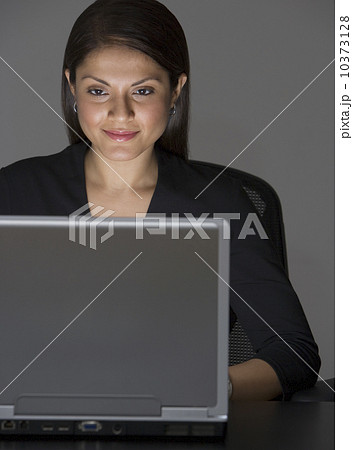 Indian businesswoman looking at laptop Indian businesswoman looking at laptop 10373128