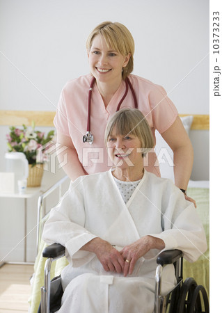 Nurse pushing senior woman in wheelchair Nurse pushing senior woman in wheelchair 10373233
