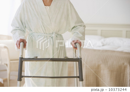 Senior woman using walker in bedroom Senior woman using walker in bedroom 10373244