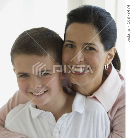 Close up of mother and son hugging 10373474