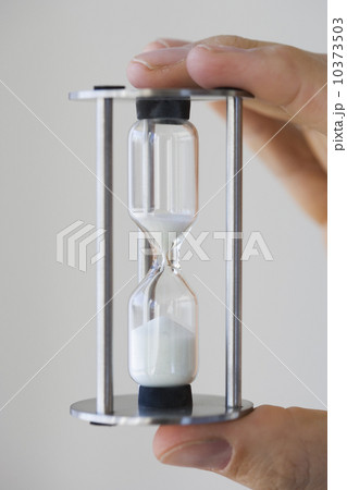 Man holding small hourglass Man holding small hourglass 10373503