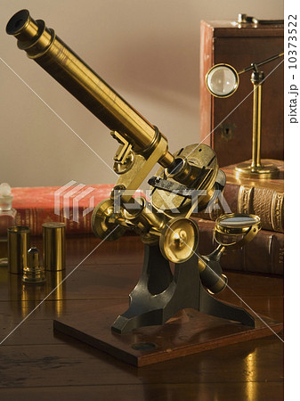Old fashioned microscope on table 10373522