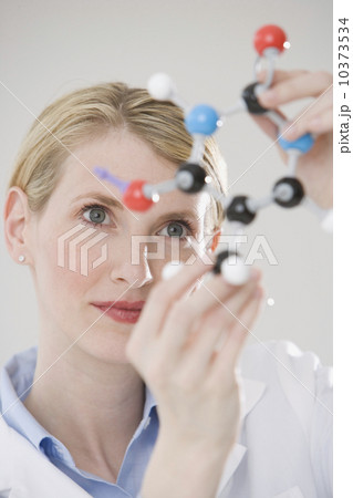Female scientist looking at molecule model Female scientist looking at molecule model 10373534