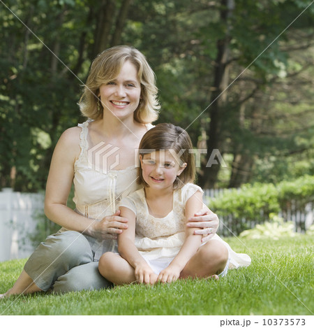 Mother and daughter hugging in grass 10373573