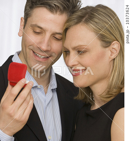 Couple looking at ring box 10373624