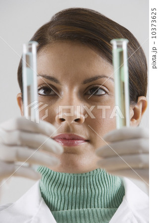 Indian female scientist looking at vials Indian female scientist looking at vials 10373625