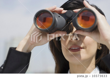 Businesswoman looking through binoculars 10373633