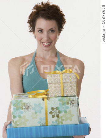 Woman holding stack of gifts Woman holding stack of gifts 10373658