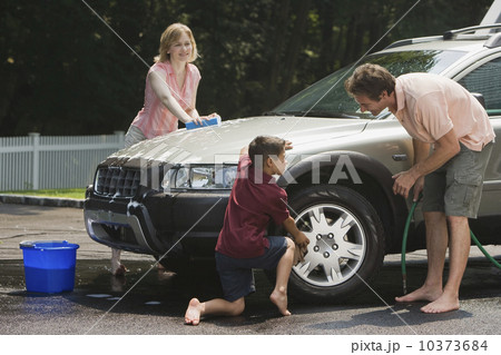 Family washing car in driveway Family washing car in driveway 10373684