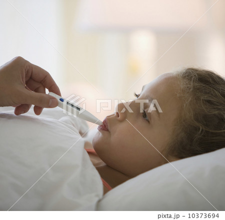 Girl having temperature taken 10373694
