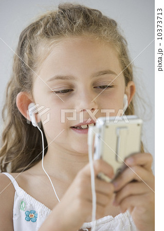 Girl listening to mp3 player Girl listening to mp3 player 10373713