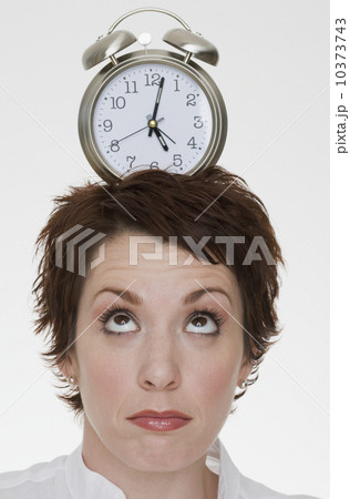Woman with alarm clock on head Woman with alarm clock on head 10373743