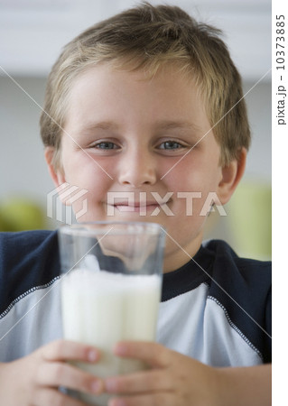 Boy holding glass of milk Boy holding glass of milk 10373885