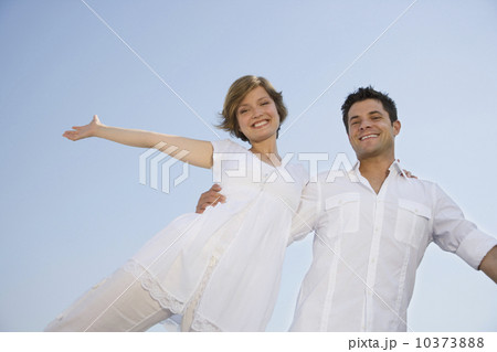 Low angle view of couple with arms outstretched Low angle view of couple with arms outstretched 10373888