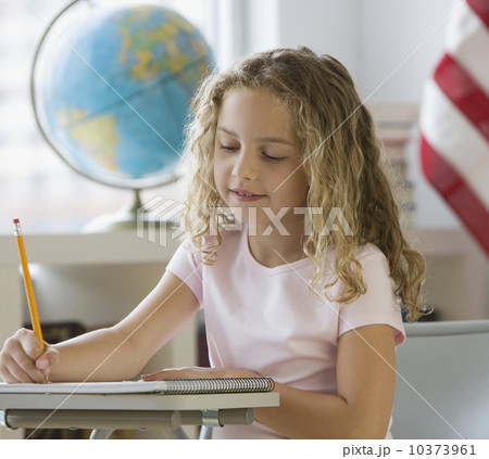 Girl writing at school desk Girl writing at school desk 10373961