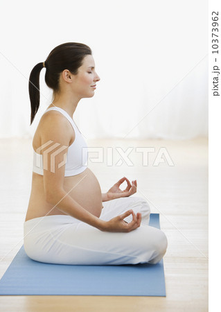 Pregnant woman practicing yoga 10373962