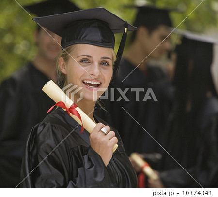 Female college graduate holding diploma Female college graduate holding diploma 10374041