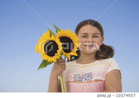Girl holding sunflowers 10374057
