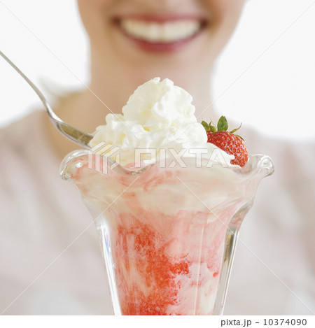 Woman eating strawberry parfait Woman eating strawberry parfait 10374090