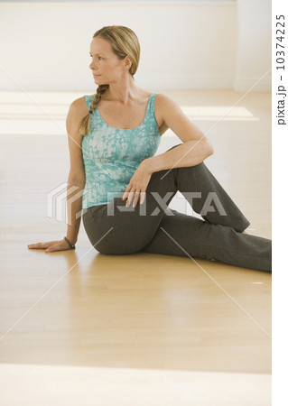 Woman stretching on floor Woman stretching on floor 10374225