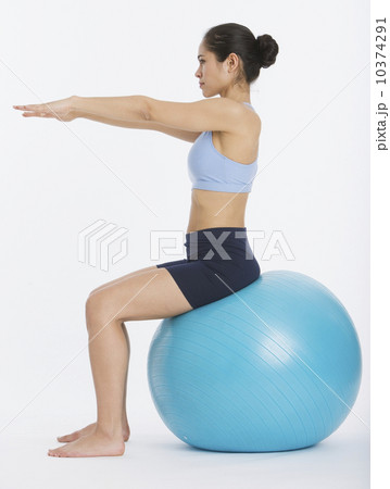 Woman sitting on exercise ball Woman sitting on exercise ball 10374291