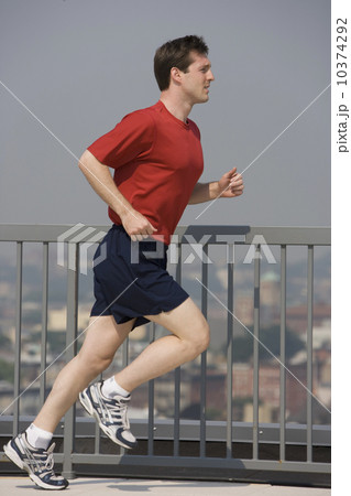 Man jogging on urban sidewalk Man jogging on urban sidewalk 10374292