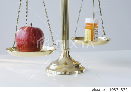 Apple and medication on scales Apple and medication on scales 10374372