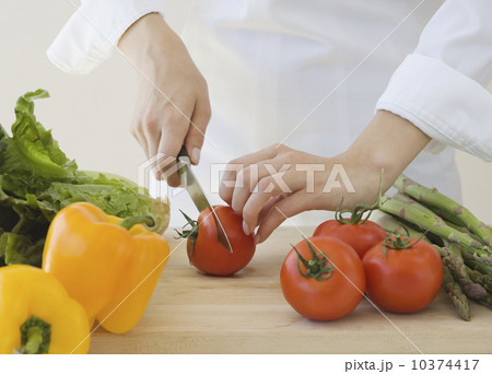 Woman chopping vegetables Woman chopping vegetables 10374417