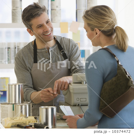 Woman talking to clerk at paint store Woman talking to clerk at paint store 10374472