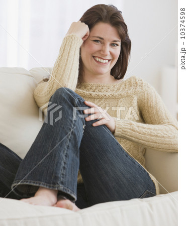 Woman sitting on sofa Woman sitting on sofa 10374598