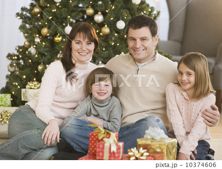 Family hugging in front of Christmas tree Family hugging in front of Christmas tree 10374606