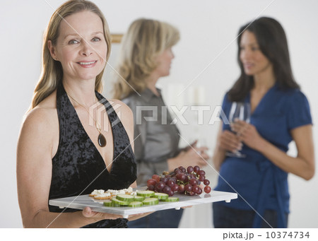 Woman carrying tray of hors d’ouevers 10374734