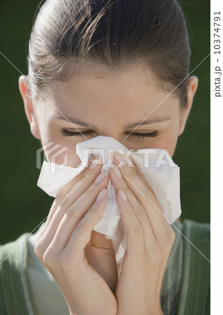 Young woman blowing nose 10374791