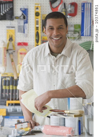 African sales clerk behind counter at hardware store African sales clerk behind counter at hardware store 10374861