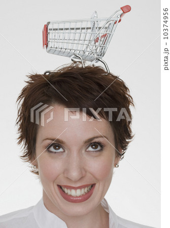 Woman with shopping cart on head Woman with shopping cart on head 10374956