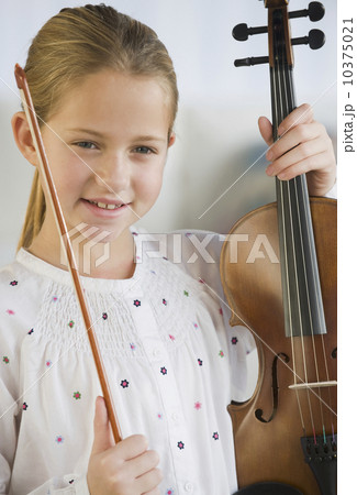 Girl holding violin and bow Girl holding violin and bow 10375021