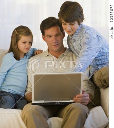 Father and children looking at laptop Father and children looking at laptop 10375072