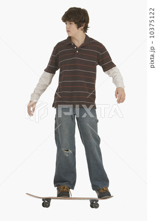 Teenaged boy riding skateboard Teenaged boy riding skateboard 10375122