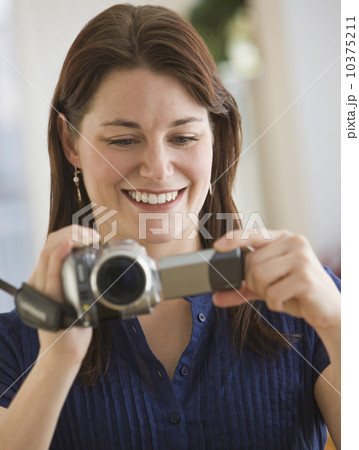 Woman looking at video camera Woman looking at video camera 10375211