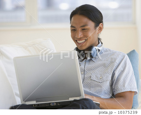 Asian man looking at laptop 10375239