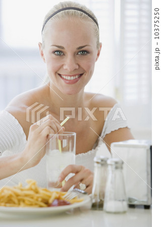 Woman eating at diner Woman eating at diner 10375250