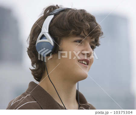 Teenaged boy wearing headphones 10375304