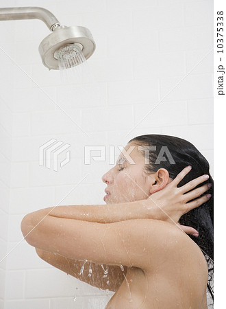 Woman standing under shower 10375338