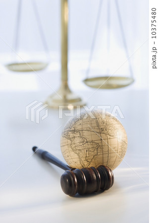 Gavel and globe with scales in background 10375480